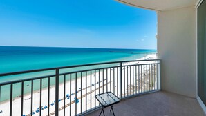 A balcony with a view of a beach and pier. - 1105 - 2BR/2BA Coastal Gulf Views (Panama City Beach)