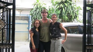 A group of people standing in front of a gate with a sign that reads "See You Again." - Fireworks Homestay (Da Nang)