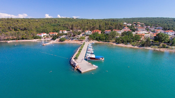 An aerial view of a coastal town with a marina, boats, and buildings. - Charming apartment for 2-4 people in Cizici in Soline Bay - contact the owner (Dobrinj, Krk)