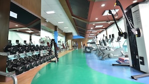 A gym with various exercise equipment, including treadmills and weight machines. - Trace Suites by SMS Hospitality (Los Banos)