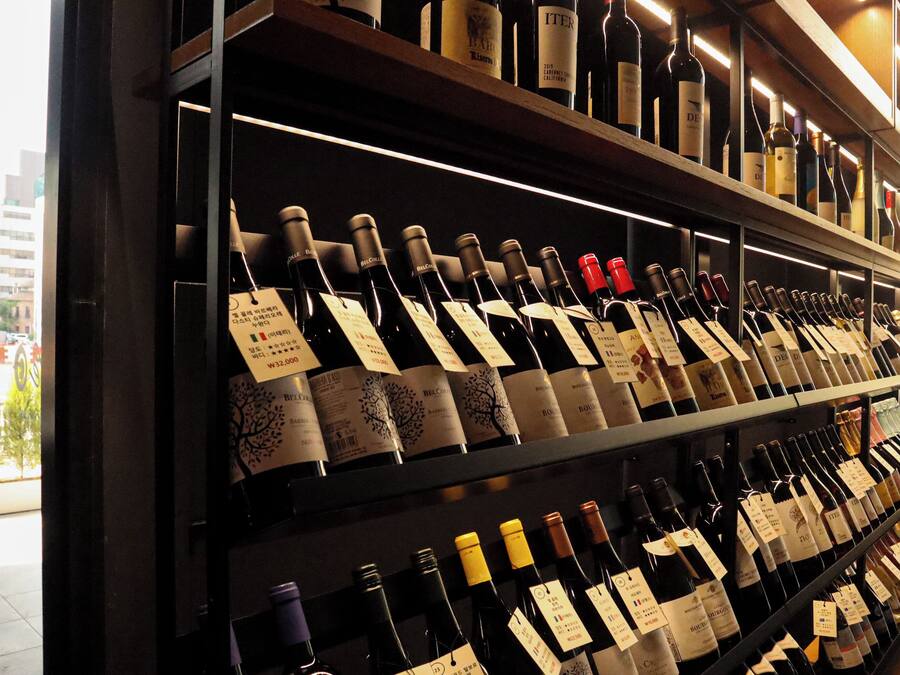 A wine rack with various bottles and labels.