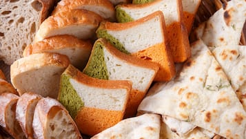 A basket of sliced bread and flatbreads.
