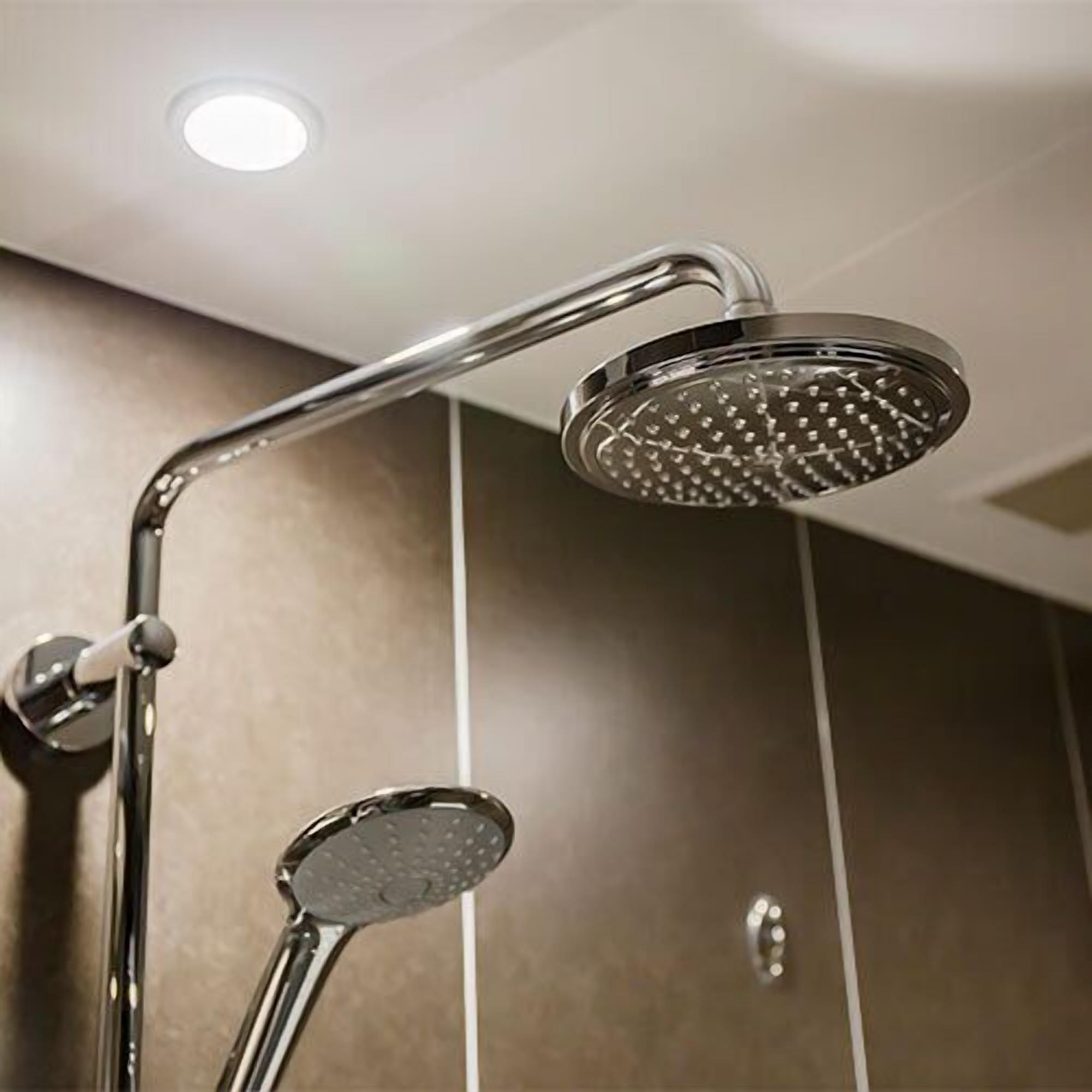 A modern shower with a curved design and a round head.
