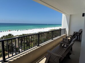 A balcony with a view of a beach and ocean. - "Breakers East 403"~Gulf Front 2BR/2BA Beach setup included (Destin)