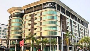 A multi-story hotel named 'LAGENDA' with a curved facade, large windows, and a prominent sign. - Grand Sri Lagenda (Bandar Baru Bangi)