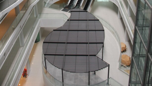 A multi-level atrium with glass railings and a central escalator. - Grand Sri Lagenda (Bandar Baru Bangi)