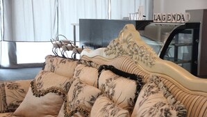 A vintage-style sofa with floral patterns and a decorative headboard. - Grand Sri Lagenda (Bandar Baru Bangi)