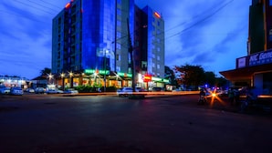 A multi-story building with a prominent entrance and signage for a restaurant and cafe.