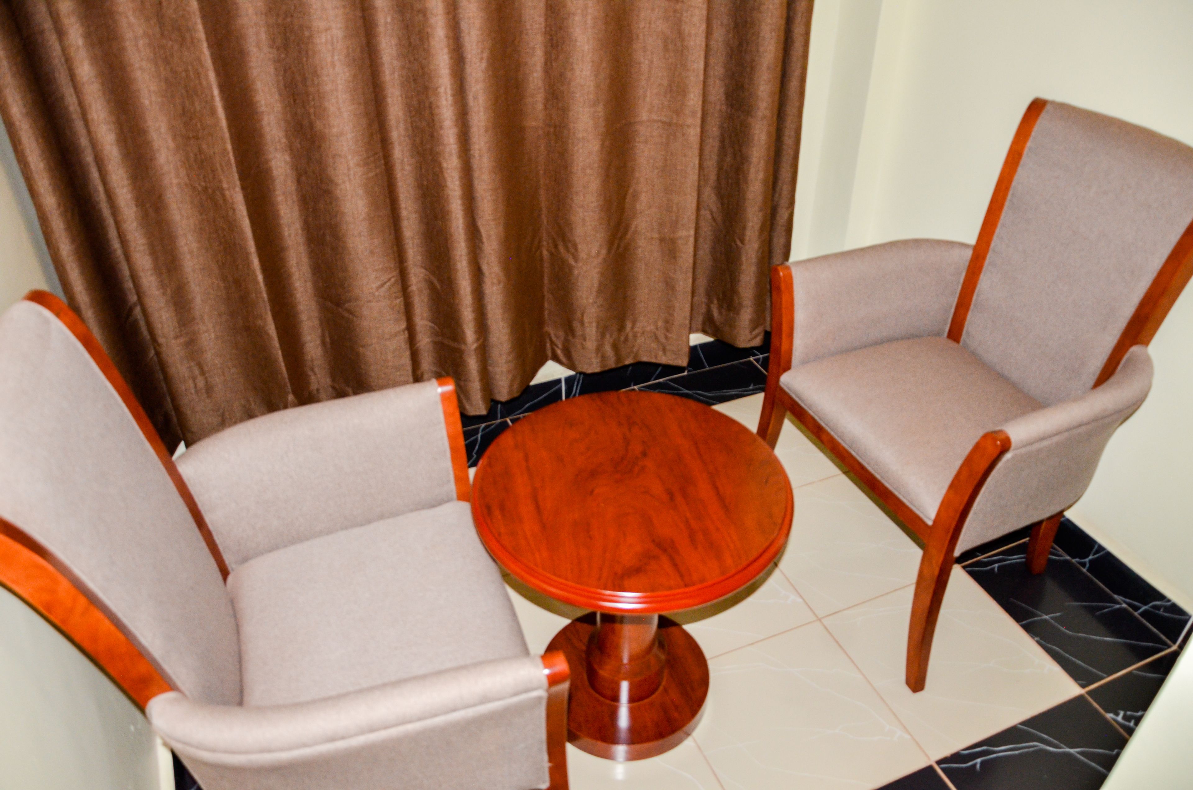 A room with two chairs and a small wooden table.