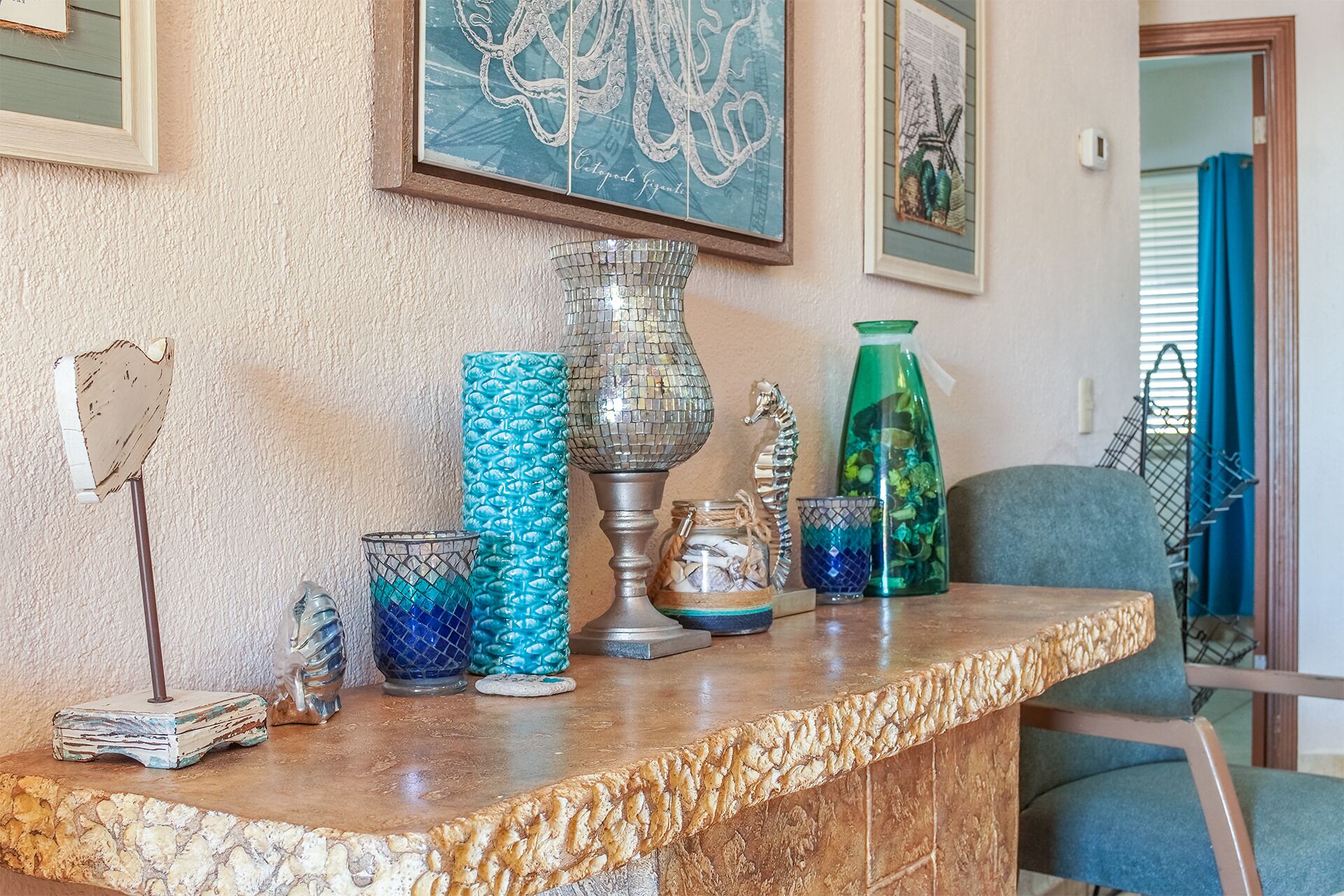 A marble countertop with decorative glassware, a metal lamp, and a framed map on the wall.