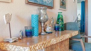 A marble countertop with decorative glassware, a metal lamp, and a framed map on the wall. - Princesa Resort B-201 Slow M'Ocean Cottage Ocean View Private Condo (Puerto Penasco)