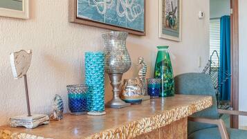A marble countertop with decorative glassware, a metal lamp, and a framed map on the wall.