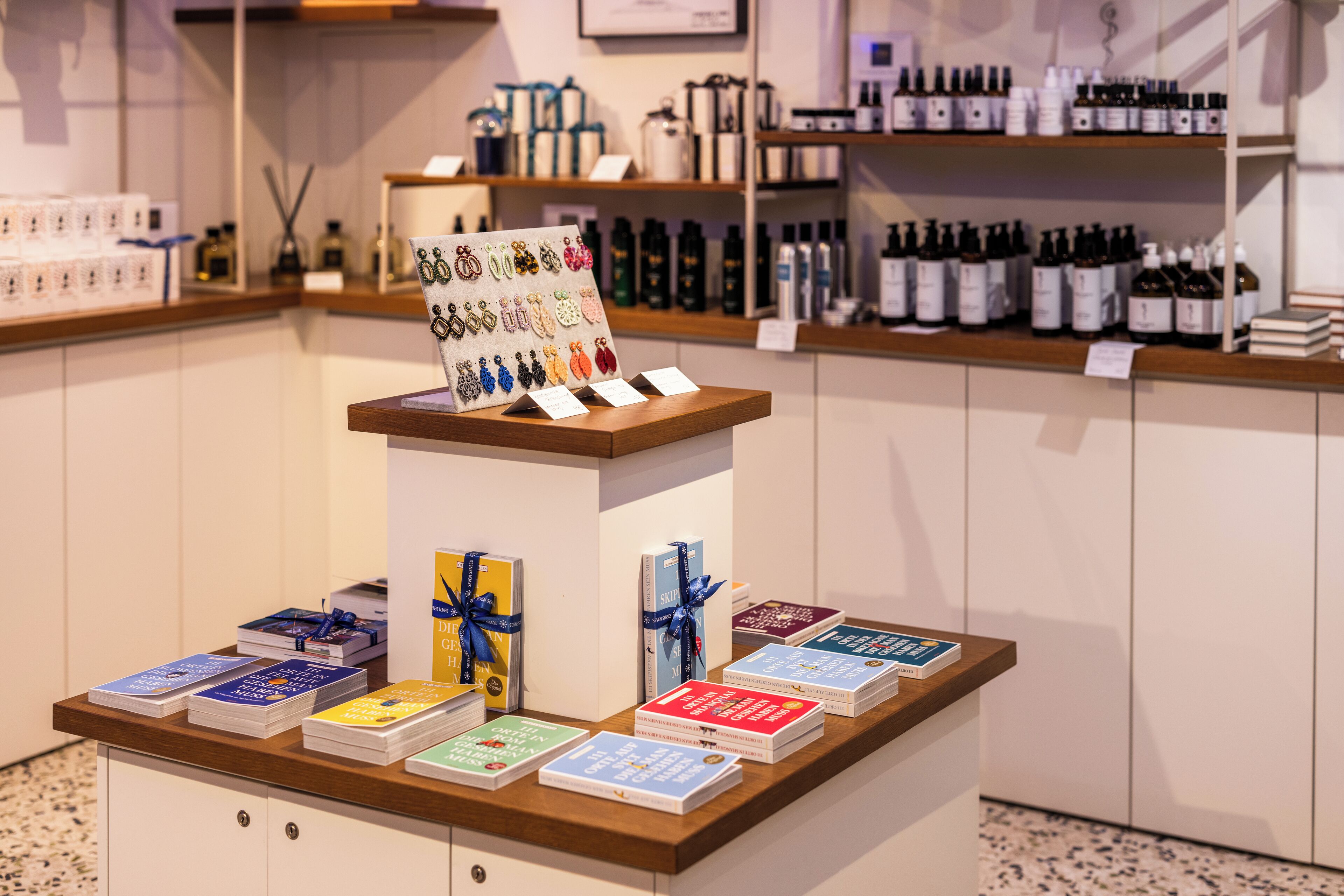 A display of books and bottles on a counter with a sign above.