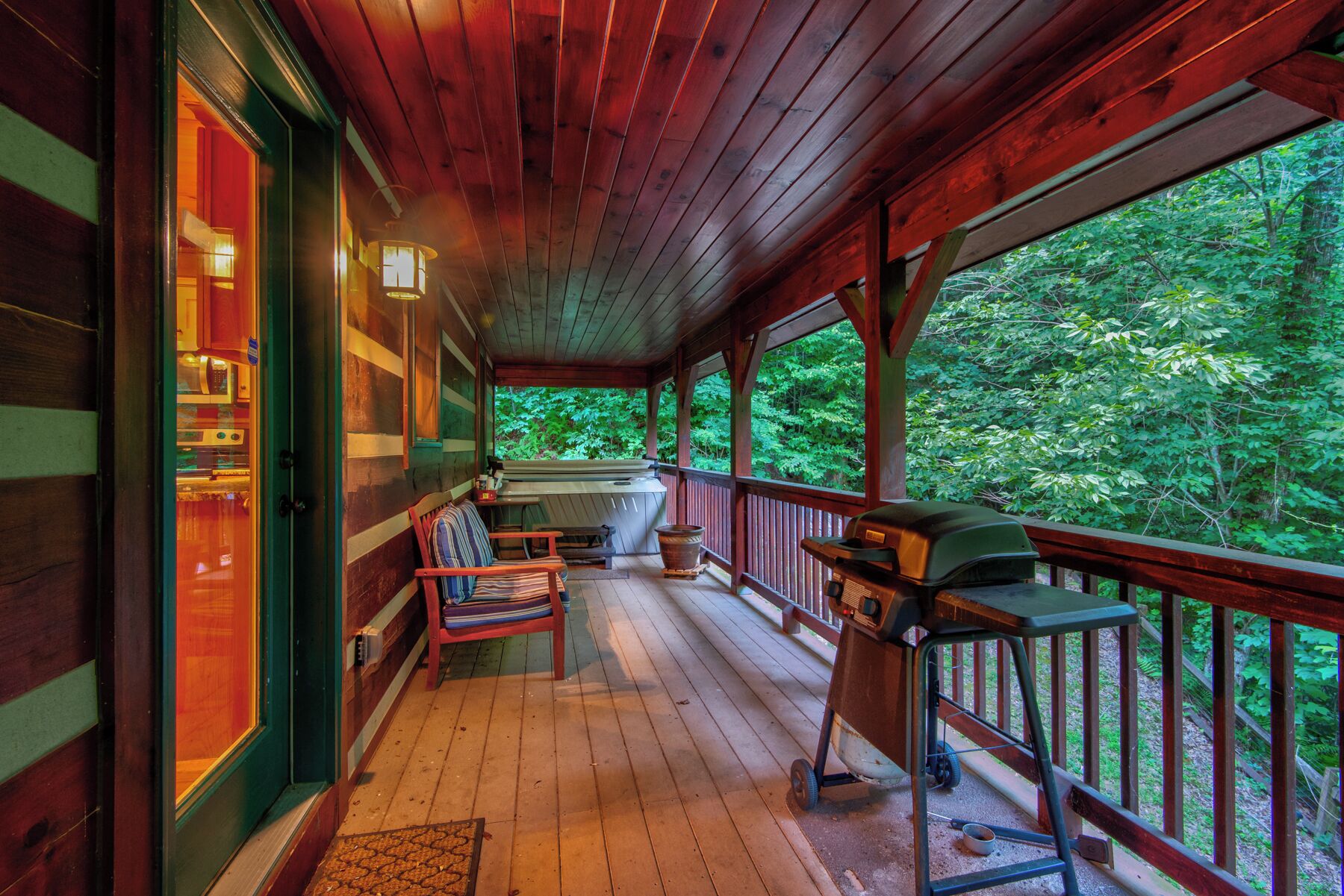 Step outside to your own private retreat, a covered porch with a hot tub, grill, and nothing but trees as far as you can see.