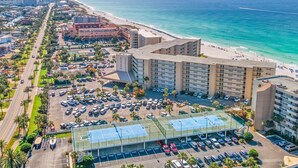 A coastal hotel with a parking lot, beachfront view, and a large building with multiple floors. - (519) Paradise Found in this Stylish, high end condo. Stunning Views! (Destin)
