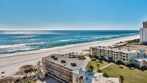 A beachfront hotel with multiple floors, a pool, and a beach view. - 2 BR Condo! Awesome Views! 14th floor!  Resort on Sand! Heart of Destin! (Destin)