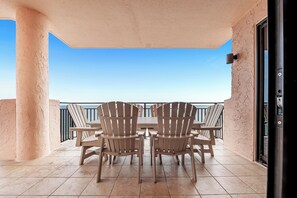Relax in style with four Adirondack chairs and a table on this balcony.