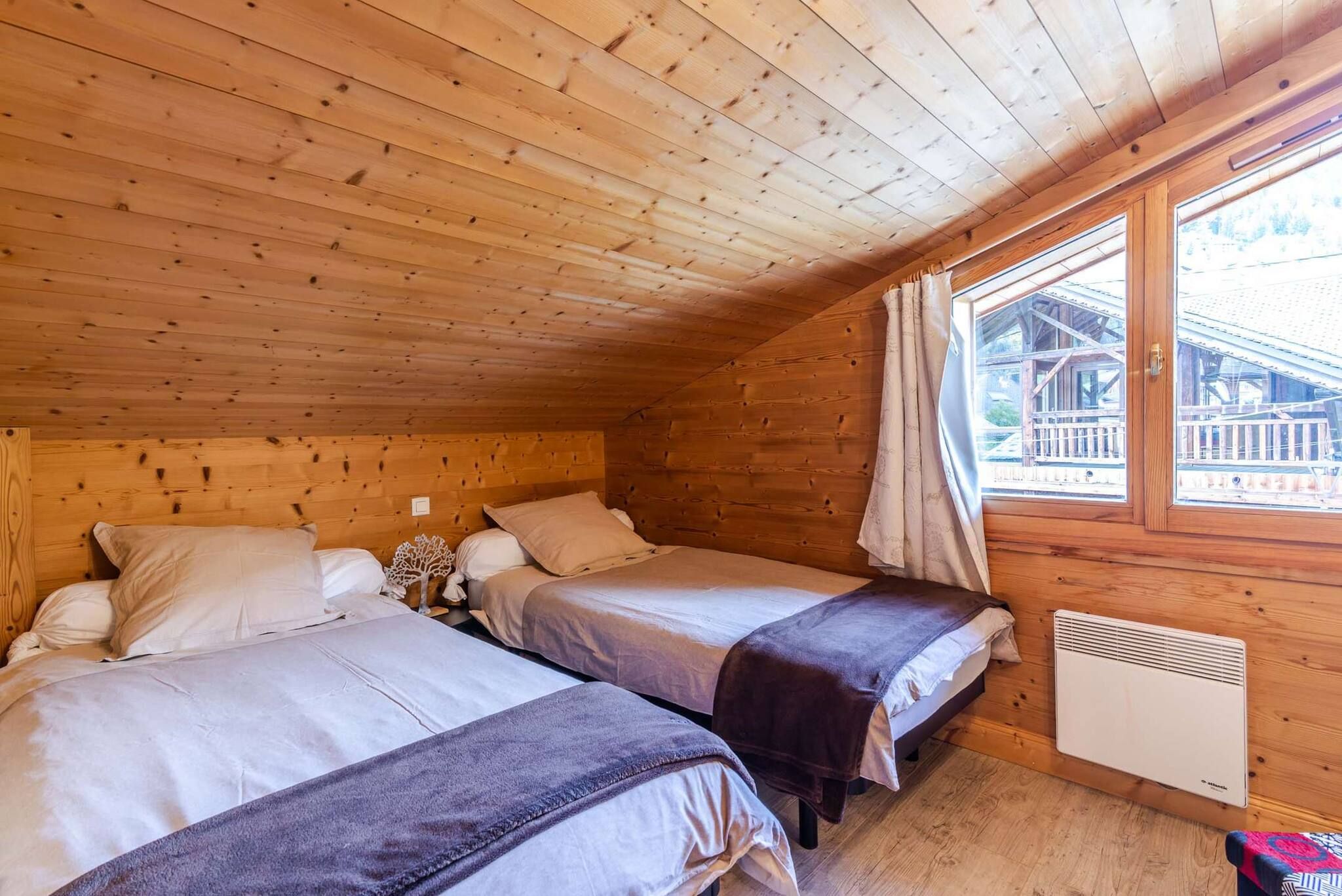A cabin with two beds, a window with curtains, and a heater.