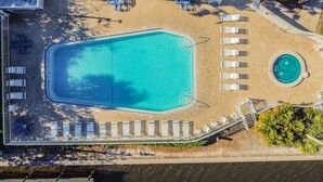 An aerial view of a resort with a large rectangular pool, a smaller circular pool, and several lounge chairs arranged around the pools. - Hideaway Studio U619 Little Harbor Resort - Tampa Bay (Ruskin)