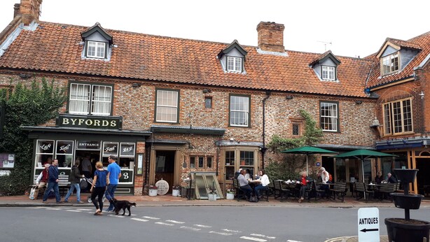 A traditional brick building with a sign reading "BYFORDS" and a cafe. - Well Cottage in Central Holt Norfolk.  Cosy. Sleeps 4 adults. Free Parking. (Holt, Norfolk)