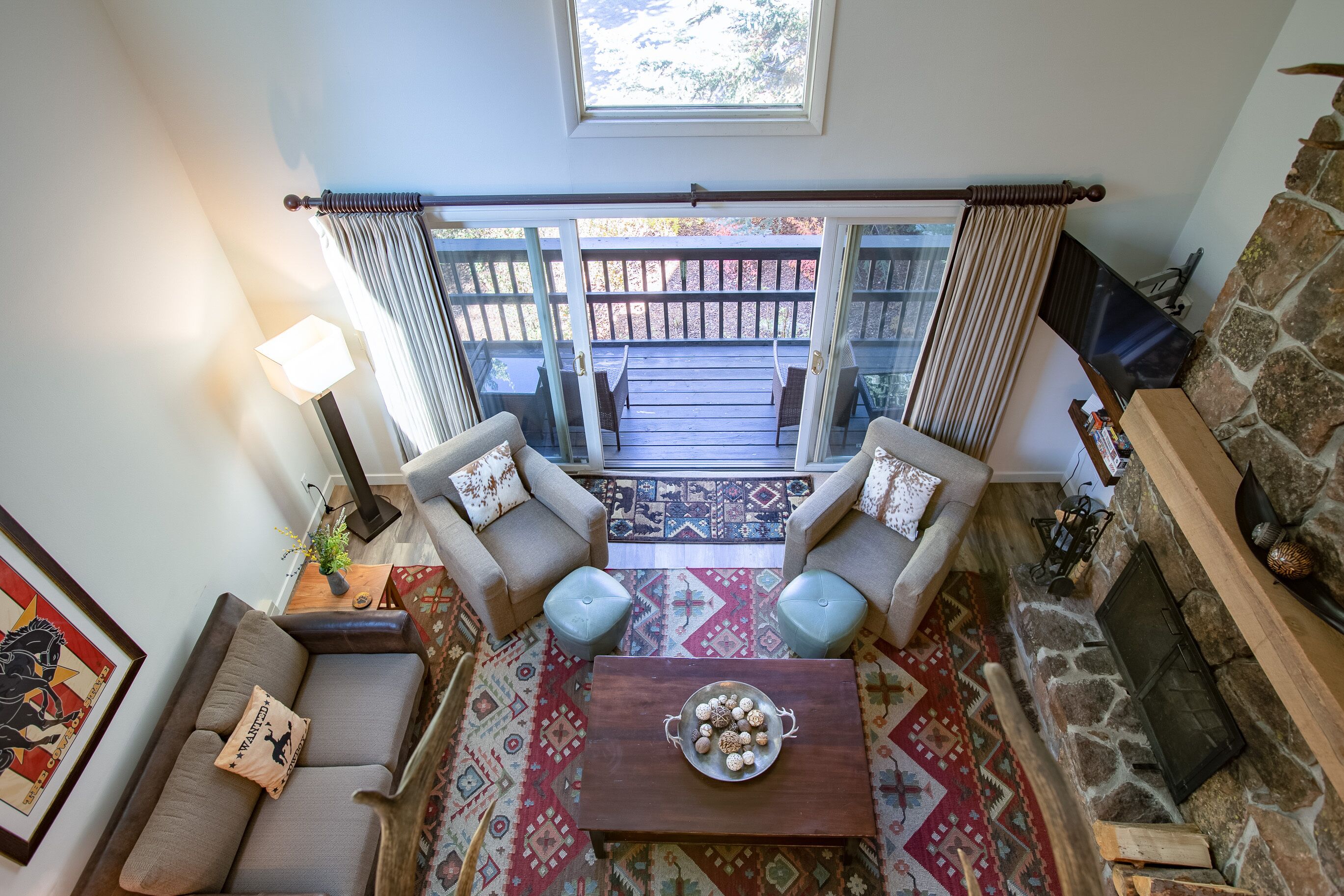 A cozy living room with a sofa, two armchairs, a coffee table, and a fireplace.