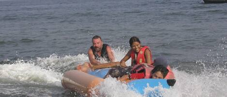 A group of people on a raft in the ocean.