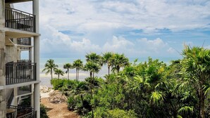 A beachfront property with a multi-level building, palm trees, and a clear view of the ocean. - **SHANG-RI-LA** Oceanview Condo/ Pool & Tennis + Last Key White Glove Service... (Key West)