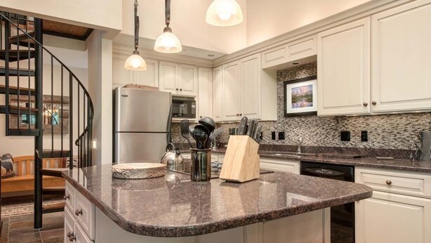 A modern kitchen with white cabinets, granite countertops, and stainless steel appliances. - JHRL - Slope-side Rendezvous C4 condo, steps from Hot tub, sleeps 9 (Teton Village)