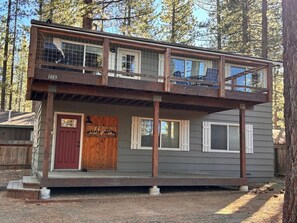 A two-story cabin with a front door, a small porch, and a number '1489' on the side.