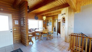 A log cabin interior with a dining area, a kitchen, and a staircase. - Juniper Ridge 5 BR Family Cabin (Blanding)