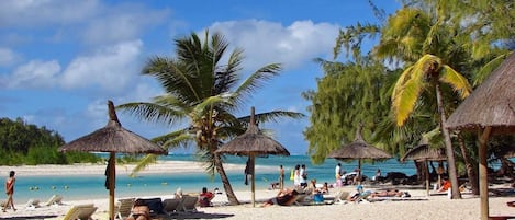 On the beach, sun loungers, beach towels