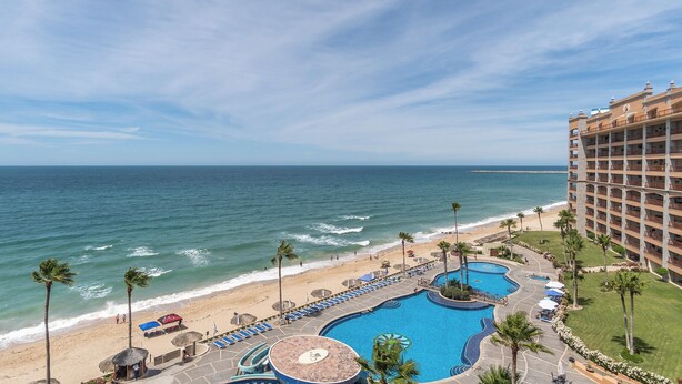A resort with a large pool area, a beach, and ocean views. - Sonoran Sun E-708 Sunset Serenity Relaxing Oceanfront Condo (Puerto Penasco)