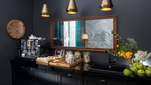 A modern kitchen with a coffee machine, jars, and a mirror. - Charme 308 (Rome)