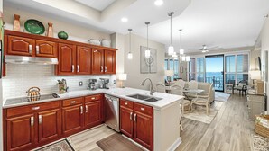 A modern kitchen with wooden cabinets, a stainless steel range, and a large island.