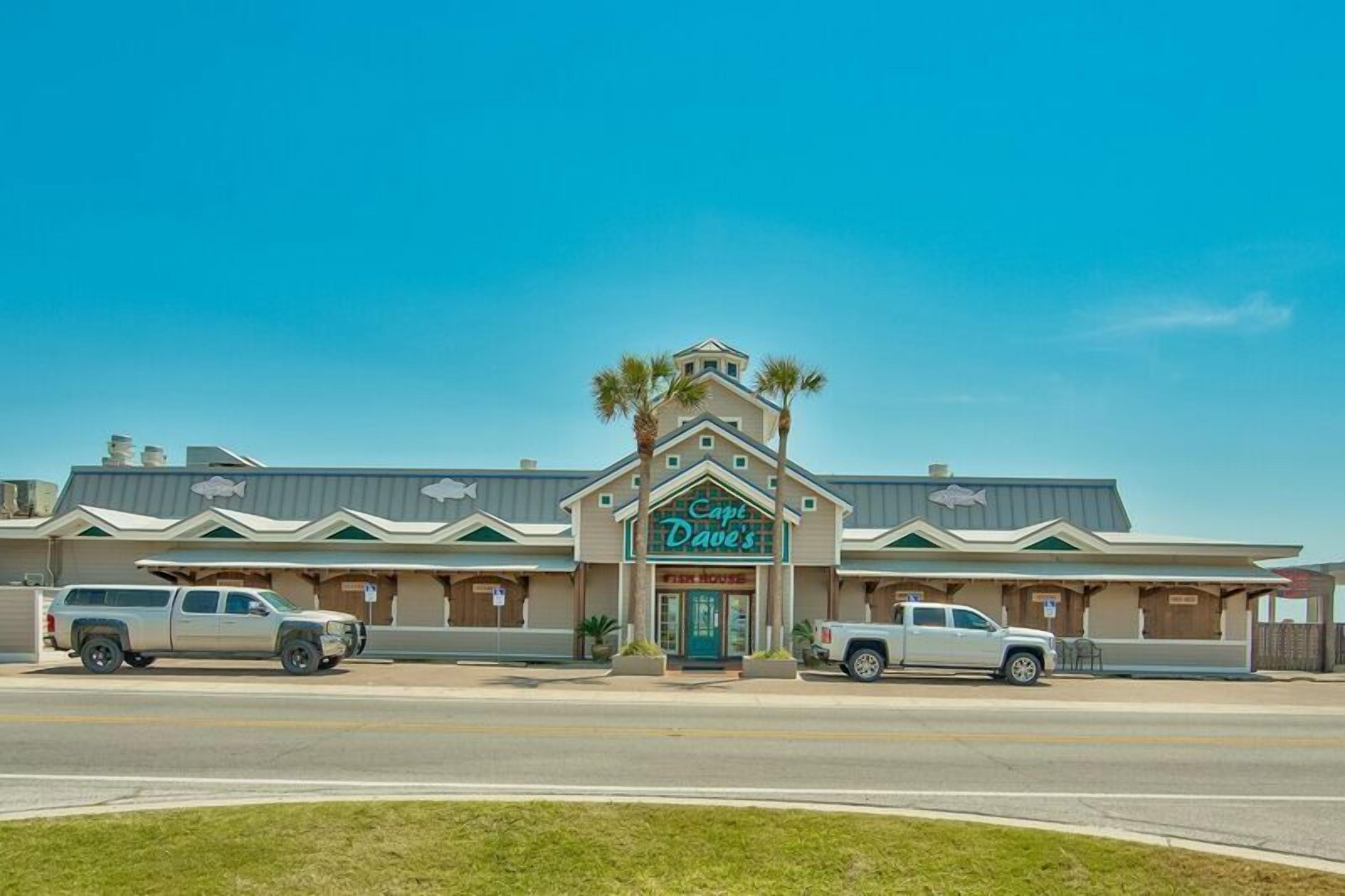 A restaurant named "Cape Dave's" with a distinctive architectural style, featuring a central entrance and palm trees.