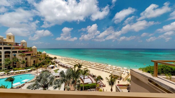 A resort with a pool, beach, and ocean view. - Astonishing Oceanfront Residence Located at The Ritz-Carlton, Grand Cayman (Seven Mile Beach)
