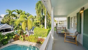 A poolside area with a covered seating area, a pool, and lush greenery. - **BRISA FRESCA @ THE ANNEX** Airy Home + Last Key White Glove Service... (Key West)