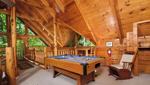 A wooden interior with a pool table, wooden furniture, and large windows. - Great location with hot tub and pool table! Cute and classy log cabin! (Sevierville)