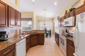 Fridge, microwave, oven, stovetop - Modern Villa w/ South-Facing Pool, Spa & Game Room Near Disney (Kissimmee)