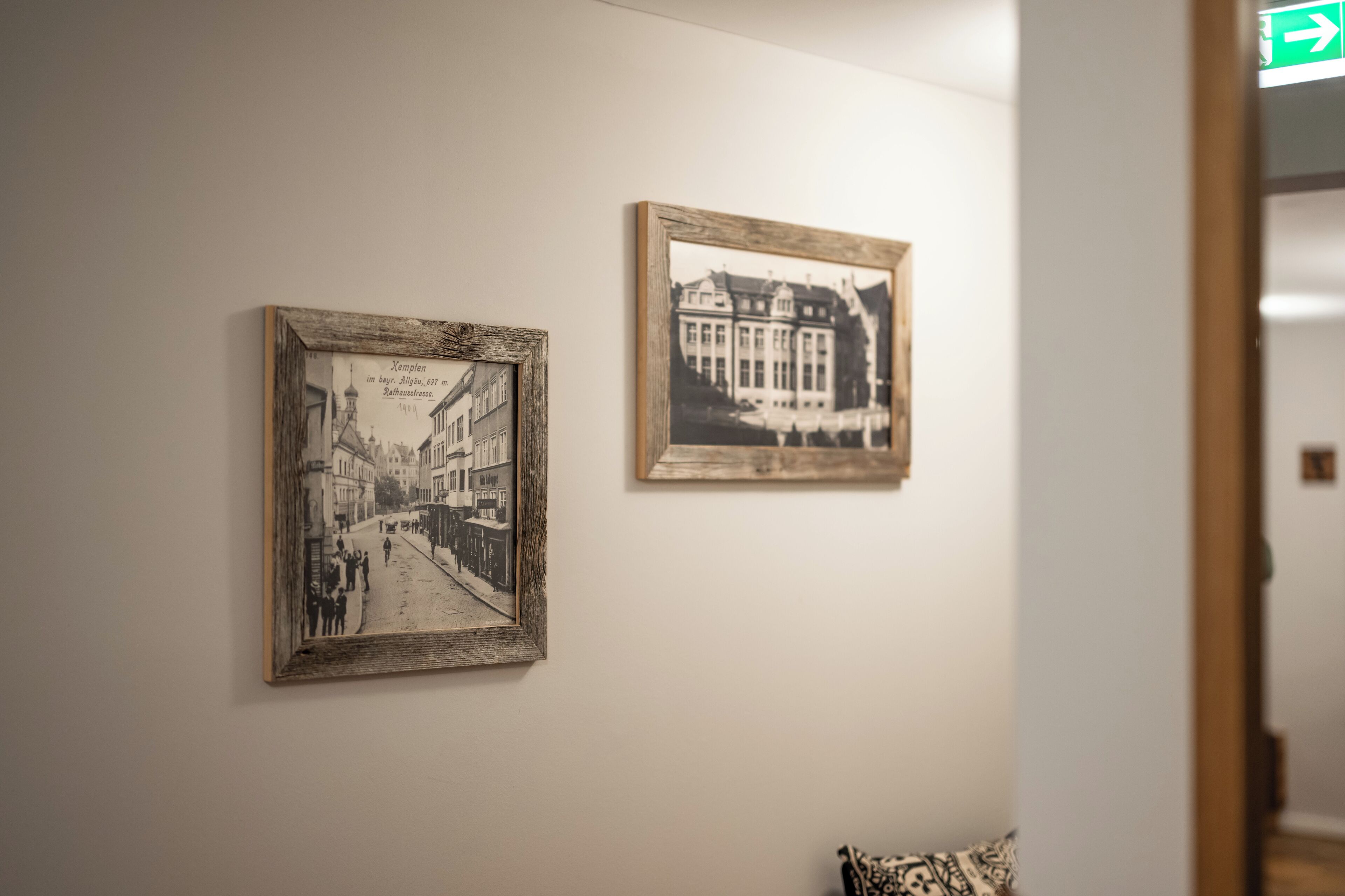 Two framed black and white photographs on a wall.