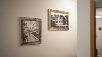 Two framed black and white photographs on a wall.