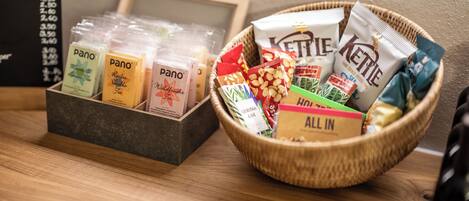 A display of packaged snacks and a menu board.