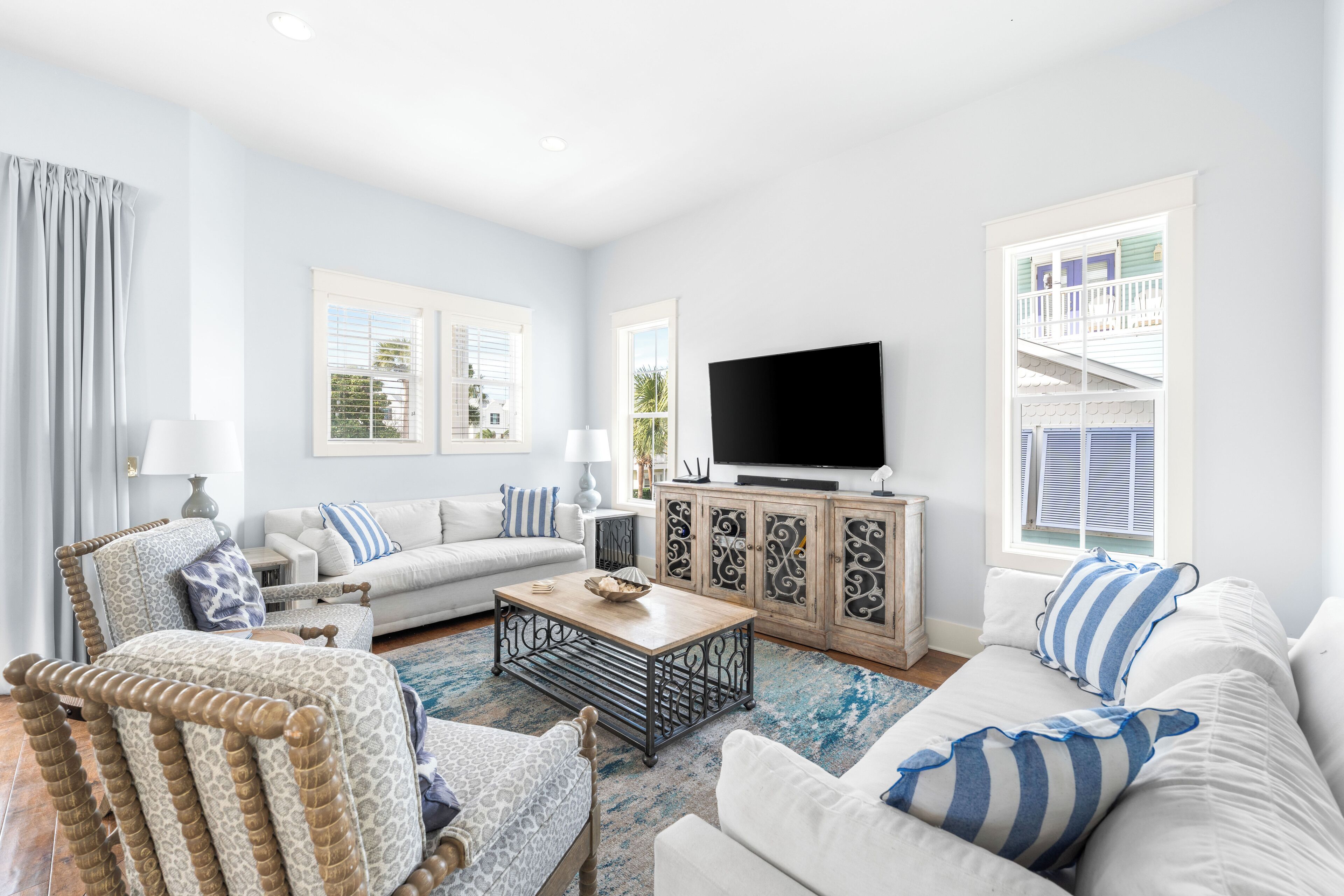 A living room with a sofa, armchair, coffee table, and TV.