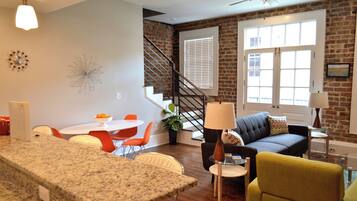 Open concetp living - dining - kitchen space with French Doors out to balcony