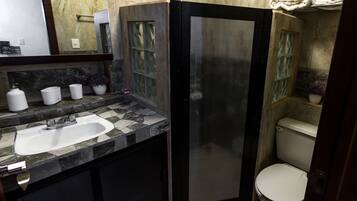 A bathroom with a sink, mirror, and toilet.