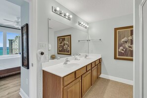 A bathroom with a double sink, vanity, and a large mirror. - Fabulous 2 BR condo! 2 Huge Pools! Fantastic Ocean Views! Great Location! (Miramar Beach)