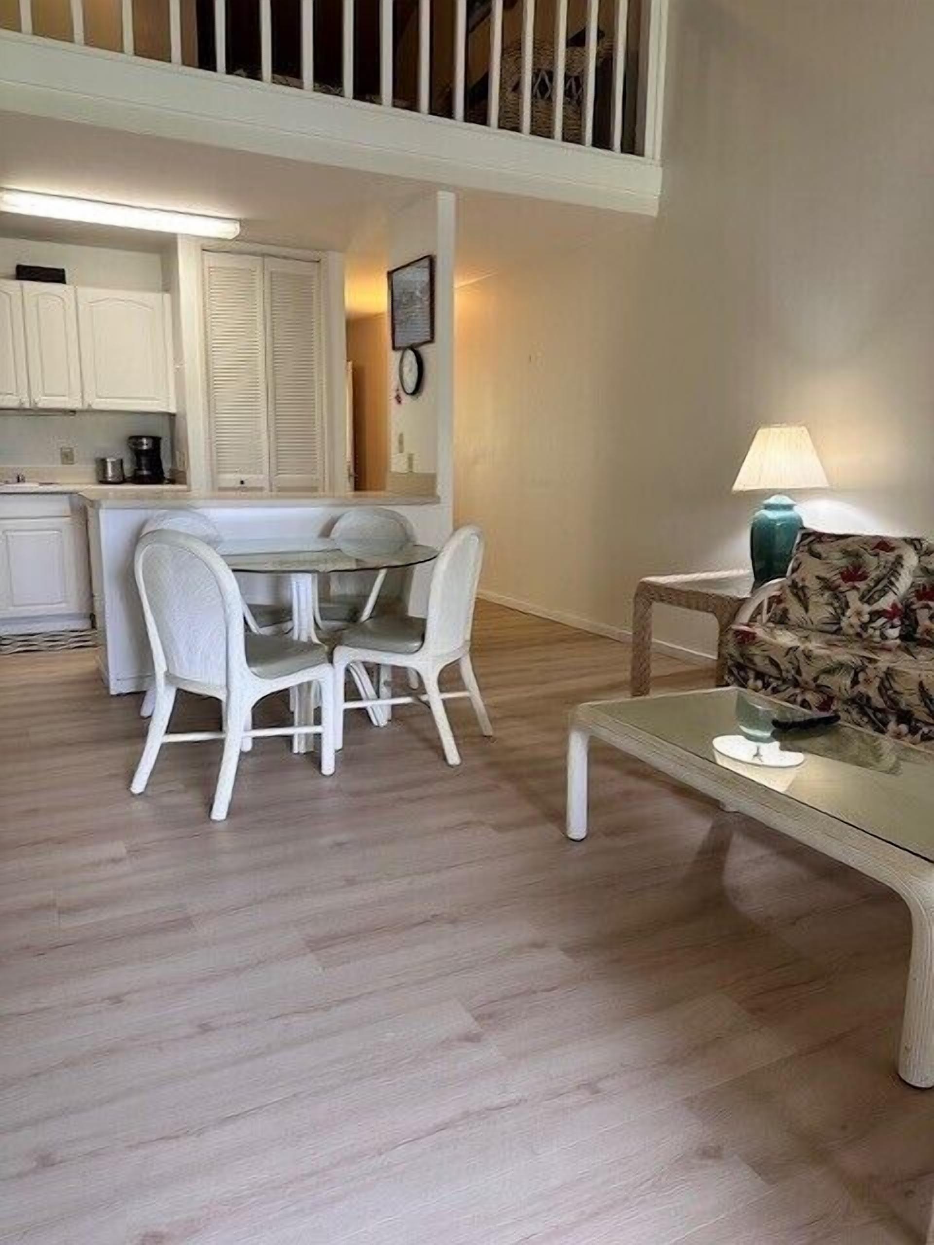 A compact living space with a dining area, a sofa, and a small table.