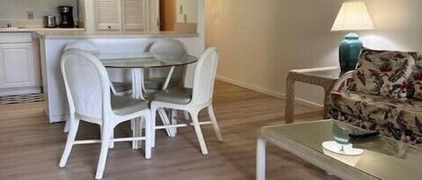 A compact living space with a dining area, a sofa, and a small table.