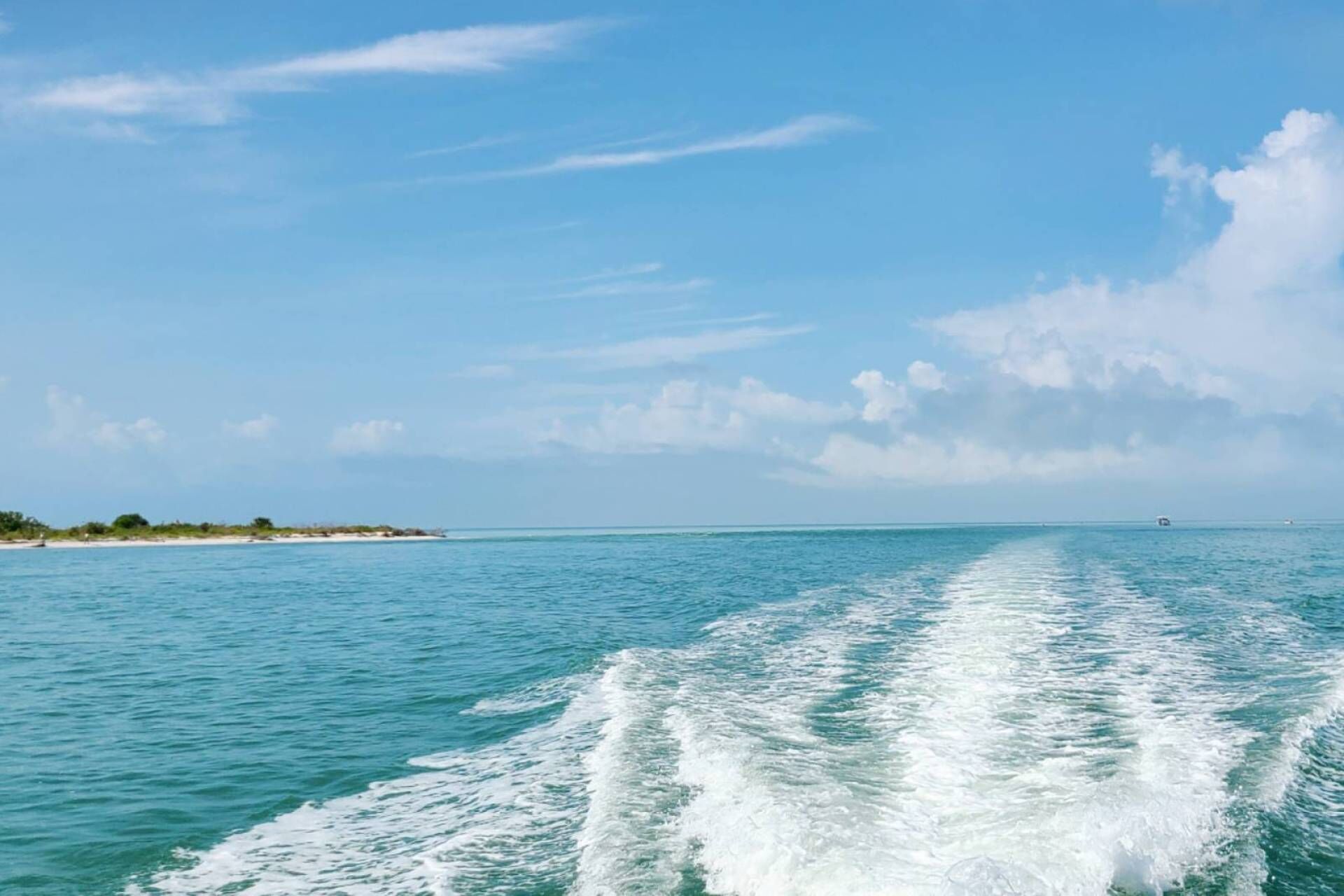 A clear view of the ocean with a wake behind a moving boat, indicating water activity.