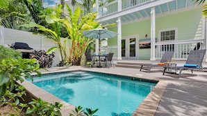 A pool with a wooden deck, a table with chairs, and a grill. - **CAYO CALYPSO @ HIGGS BEACH** Home / Pool + Last Key White Glove Service... (Key West)
